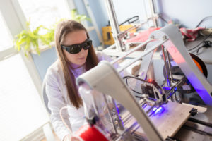 Woman working with laser engraver
